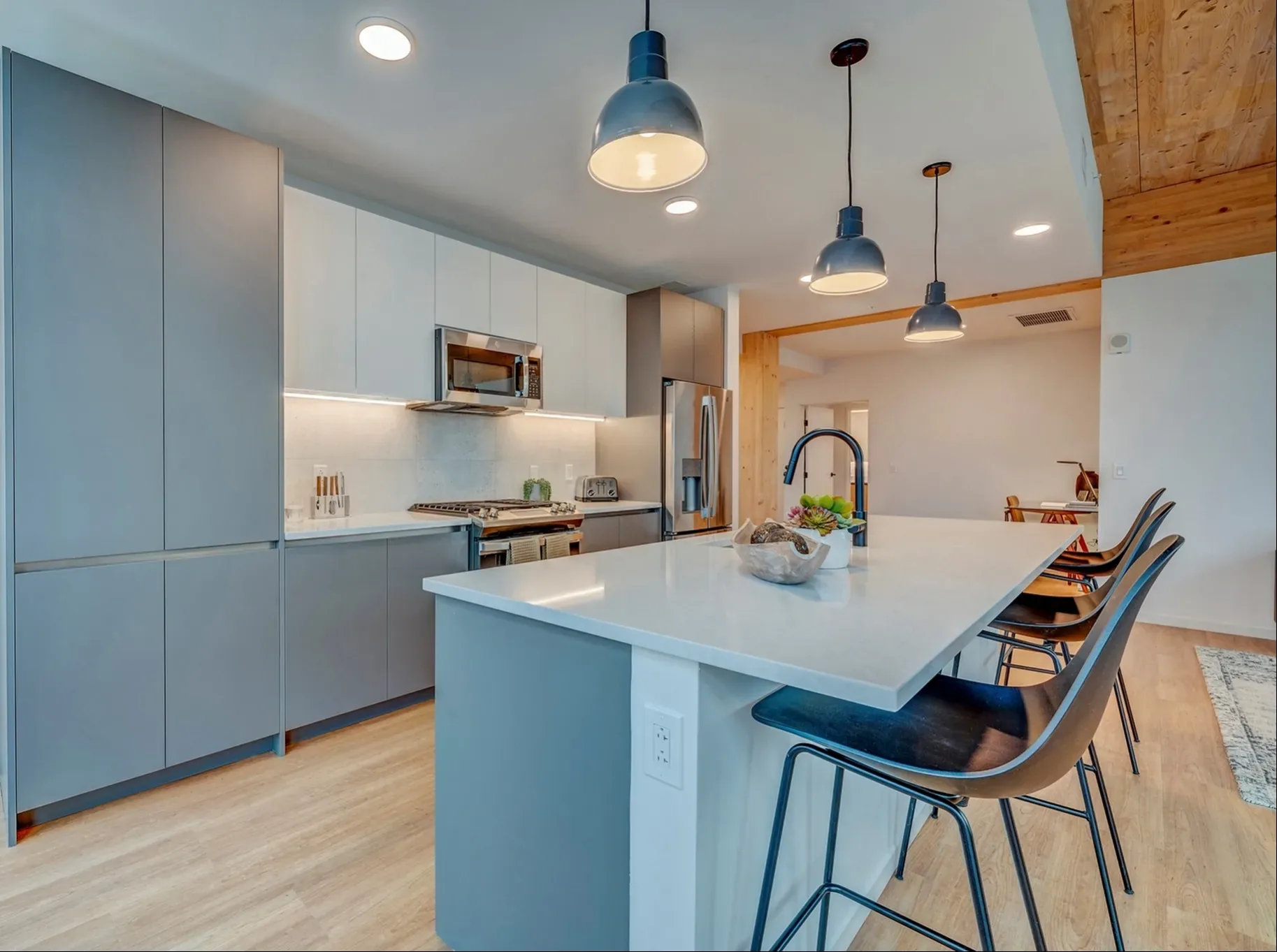 INTRO residence interior — warm timber finishes and skyline light