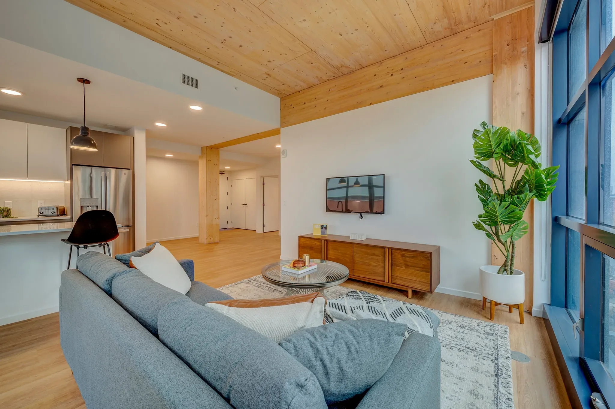 INTRO residence interior — warm timber finishes and skyline light