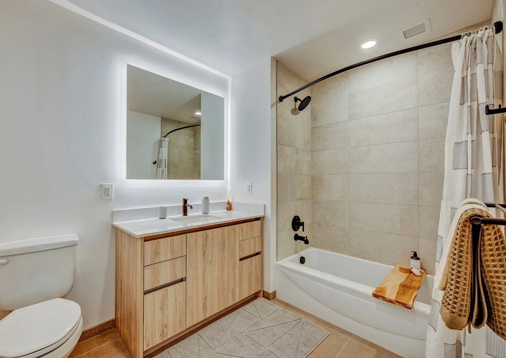 INTRO residence interior — warm timber finishes and skyline light