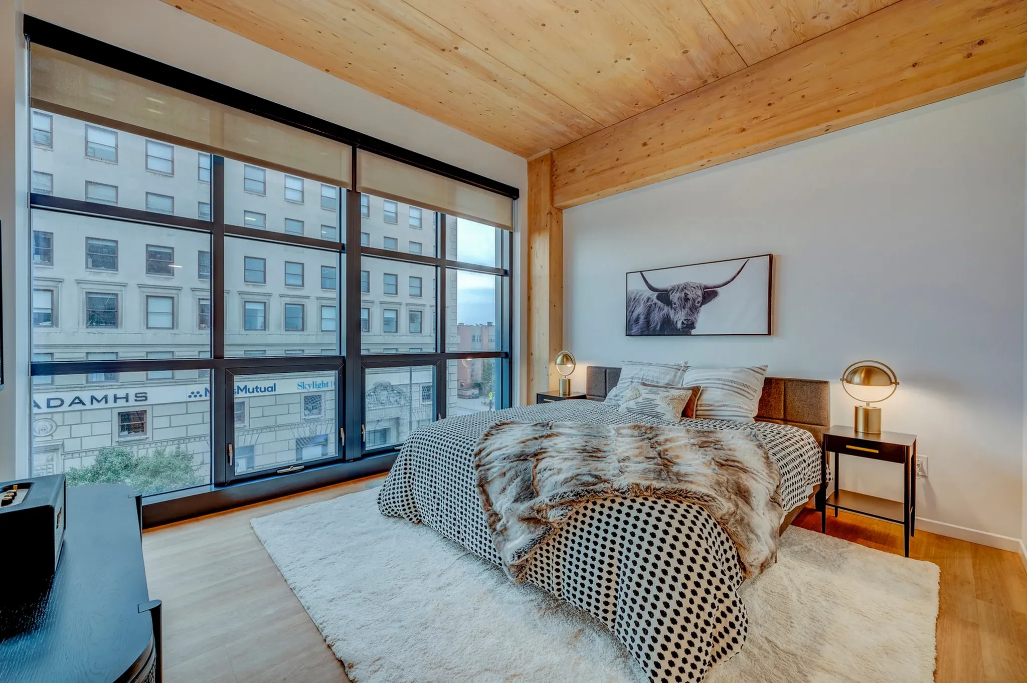 INTRO residence interior — warm timber finishes and skyline light
