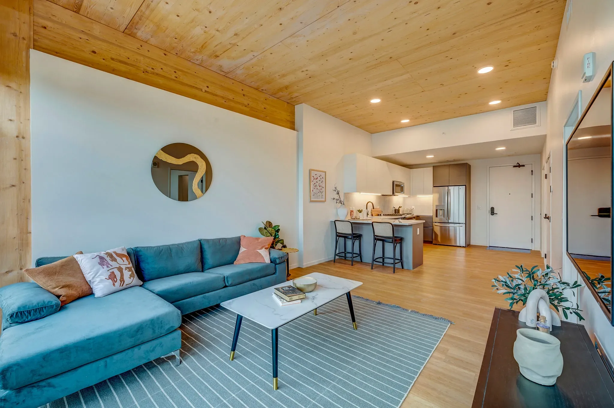 INTRO residence interior — warm timber finishes and skyline light