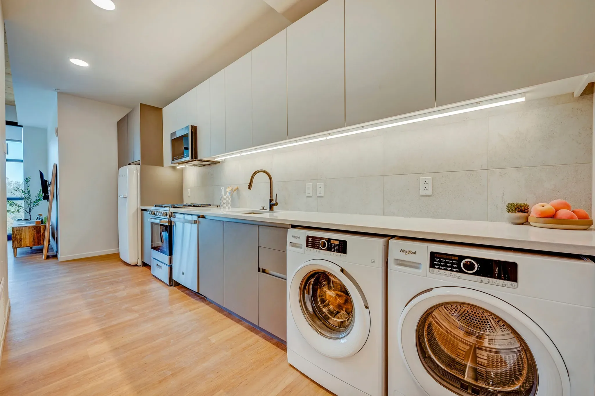 INTRO residence interior — warm timber finishes and skyline light