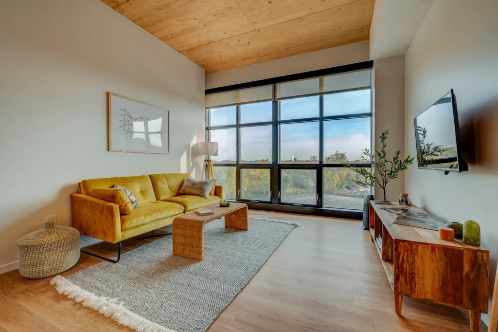 Living space with gold sofa and skyline windows