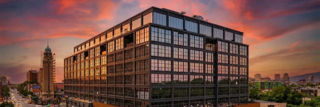 INTRO, Cleveland's mass-timber residential tower at dusk, with the downtown skyline beyond